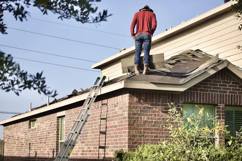 Professional roofer working on a residential roof in Sunset Hills